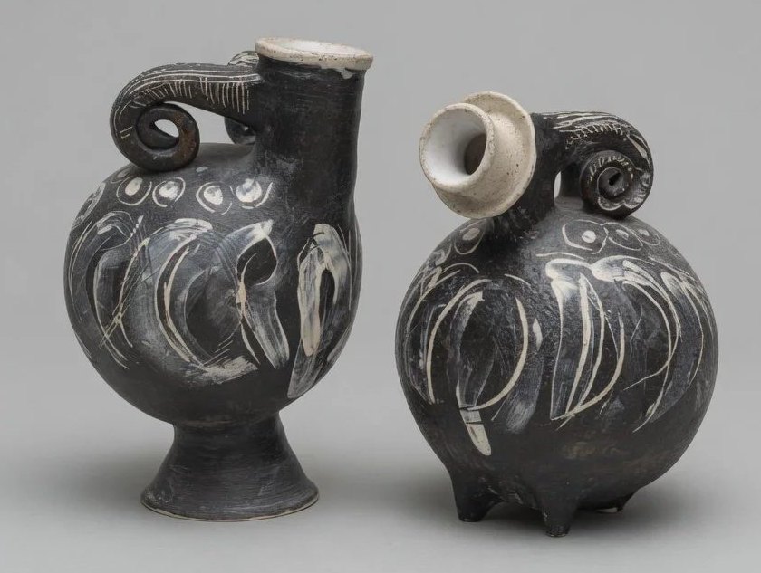 Two abstracted ceramic bird forms in Oaxacan-style blackware with white slip detailing.